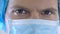 Male surgeon face in mask looking confidently closeup, reliable medical services