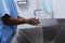 Male surgeon washing hands in sink at hospital