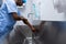 Male surgeon washing hands in sink at hospital