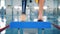 Male swimmer with bionic prosthesis warming up near a pool.