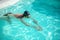 Male swimmer near the poolside starting to swim