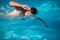 Male swimmer swimming crawl in an outdoor pool