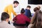 Male teacher clearing up complicated issue to pupil during exam