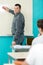 male teacher duster white board