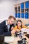 Male teacher and girl sitting at desk, studying buildable car