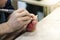 The male teacher and his little student make a hand-made walrus bone souvenir