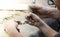 The male teacher and his little student make a hand-made walrus bone souvenir