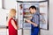 Male Technician Checking Fridge With Digital Multimeter