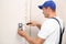 Male technician installing fingerprint security alarm system