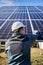 Male technician installing photovoltaic blue solar module.