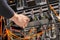 Male Technician Plugging Power Cable In Panel At Datacenter