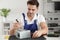 Male technician repairing power supply unit at table