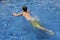 Male teen swimming in water