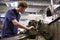 Male Teenage Apprentice In Engineering Factory Using Lathe