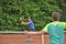 Male teenage tennis player hitting a forehand