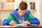 Male teenager concentrated doing homework