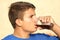 male teenager is drinking a glass coke