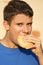 male teenager eating a bread roll