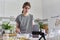 Male teenager learns to cook pancakes, watching video recipe on smartphone