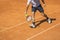 Male tennis player in action on the clay court