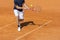 Male tennis player in action on the clay court