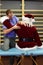 Male therapist massaging stressed Santa Claus