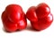 Male three-chamber and female four-chamber two red sweet peppers on a white background