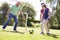 Male Three Generation Family Playing Football Together