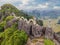 Male tourist on the background of Amazing huge dragon statue at limestone mountain top near Hang Mua view point at foggy