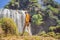 Male tourist on the background of Elephant waterfall near Dalat city in Vietnam