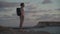Male tourist with backpack watching beautiful view of Yeronisos Holy Island near coast Agios Georgios Pegeias In Cyprus