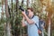 A male tourist carrying a handbag, water bottle and camera walks through the forest