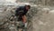 Male tourist drinking water from the mountain stream, thirst