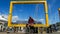 Male tourist with face mask sitting on yellow frames which frames Table Mountain and has Cape Town`s coordinates on it