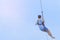 A male tourist flying on a zipline aka flying fox across the lake