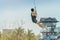 A male tourist flying on a zipline aka flying fox across the lake at Pattaya Floating Market