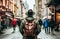 A male tourist in a hat with a backpack walks along a city street. View from the back