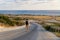 Male tourist hikers on an asphalt mountain road overlooking the sea in Cyprus near Agios Georgios Pegeias. Roadway