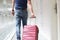 Male tourist pulls suitcase moving to luxury hotel