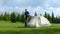 Male tourist puts a tent in the mountains