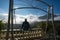 Male tourist sit on balcony seeing mountain landscape with low white clouds under brilliant sky. Ideas for travel and feeling.