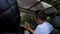 A male tourist is sitting in a jeep with a phone, traveling in the mountains.