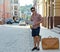 Male tourist with a suitcase and map