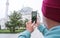 A male tourist takes a photo of the Fatih Mosque in Istanbul, Turkey as a keepsake.