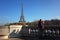 Male tourist taking photo of Eiffel Tower from observation deck on Bir-Hakeim bridge