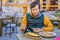 Male tourist tries Traditional Montenegrin Meal. Kacamak in a black pan