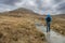 Male tourist walking towards Diamond hill, Connemara National Park, Ireland. Travel and hiking concept. Popular tourist area with