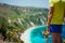 Male tourist wearing shorts on Petani beach Kefalonia enjoying picturesque panorama of emerald azure bay lagoon