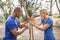 Male trainer assisting woman in rope climbing during obstacle course