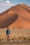 Male traveler standing in Namib desert, Namibia